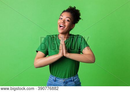 Desire Concept. Portrait Of Excited African American Woman Pressing Hands Together, Asking To Buy So