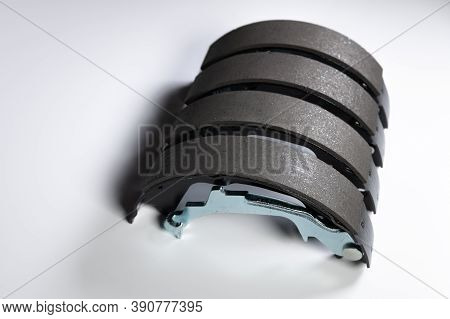 New Set Of Four Brake Pads For Drum Brakes On A Gray Background