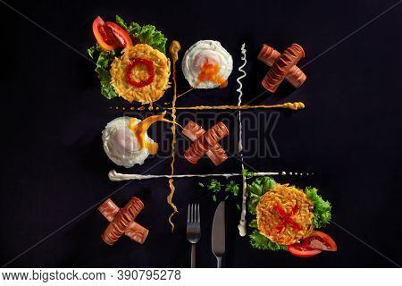 Potato pancakes, poached egg with yolk splash and fried sausages like tic-tac-toe board game concept on dark background with copy space. Grid is divided by mustard and mayonnaise