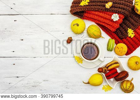 French Macarons In Autumn Colors With Cup Of Hot Tea