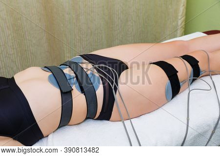 Myostimulation Electrodes Are Installed On The Abdominal Muscles Of A Young Woman. A Slender Woman U