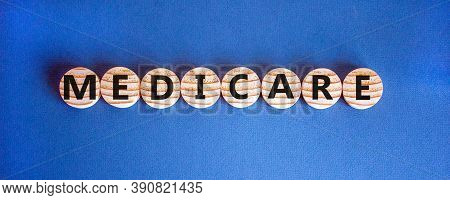 Wooden Circles With Word 'medicare'. Beautiful Blue Background. Medical Concept. Copy Space.