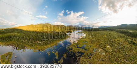 Peaceful Panoramic Lake View From Above At Sunset, Surrounded By Lush, Green Forest In Canadian Natu