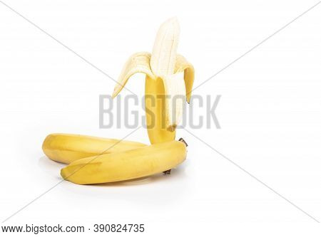 Shooting In The Studio. A Branch Of Ripe Yellow Bananas In A Peel. On White Background. Close-up.