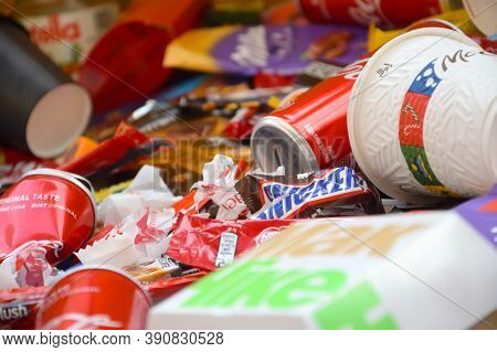 Many Wrappings And Cans From Used Products By Famous Worldwide Brands. Pattern Of Trash Of Various C