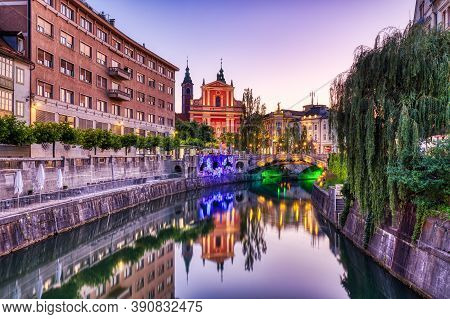 Ljubljana City Center At Dusk Overlooking Lublanka River And Beautiful Franciscan Church, Slovenia
