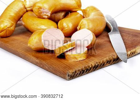 Shooting In The Studio. Meat Products, Semi-finished Products. Sausage Pork Sausages On A Wooden Tra