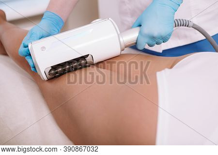 Cropped Shot Of A Female Client Getting Endospheres Therapy At Beauty Spa. Beautician Massaging Back