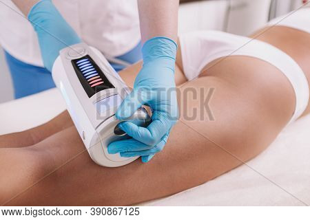 Cropped Shot Of A Woman Getting Body Sculpting Treatment At Beauty Clinic. Cosmetologist Using Endos