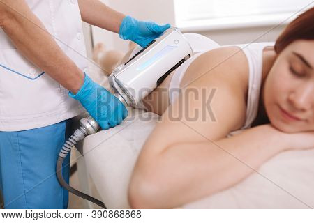 Cropped Shot Of A Professional Cosmetologist Using Endospheres Therapy Machine On A Female Client