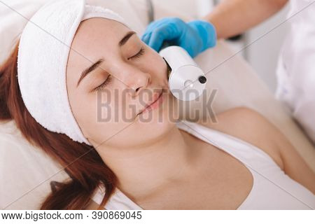 Close Up Of A Young Woman Relaxing While Getting Facial Endospheres Massage At Beauty Clinic
