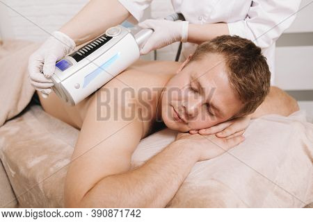 Relaxed Man Enjoying Full Body Massage With Endospheres Massager By Professional Therapist