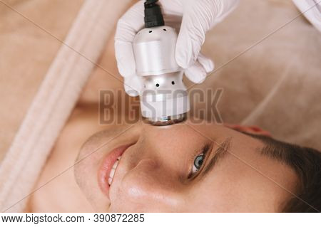 Cropped Top View Shot Of A Handsome Man Enjoying Hardware Skincare Treatment By Cosmetologist