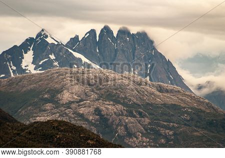 Sarmiento Channel, Chile - December 11, 2008: Amalia Glacier And Fjord. Blackish Mountain Peaks With