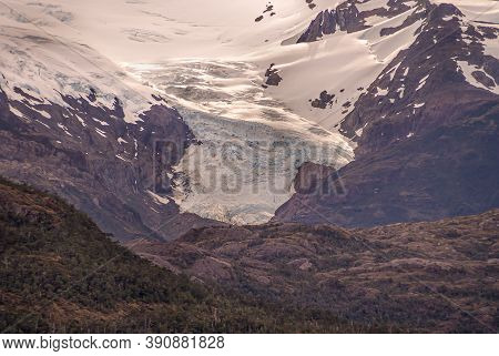 Sarmiento Channel, Chile - December 11, 2008: Closeup Of Amalia Glacier Above Belt Of Brown Rocks An
