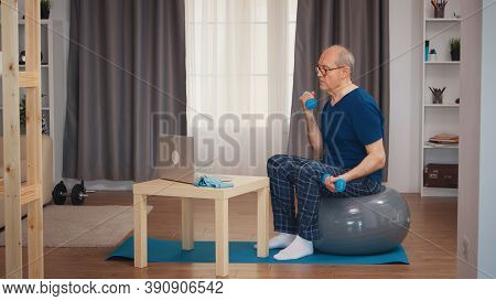 Senior Man Training Biceps Watching Online Fitness Lesson. Old Person Pensioner Healthy Training Hea