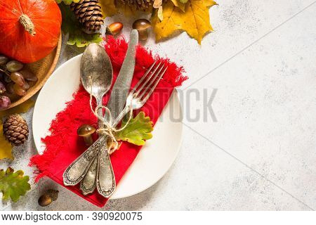 Thanksgiving Food Concept. Autumn Table Setting With Craft Plate, Silverware And Fall Decorations At