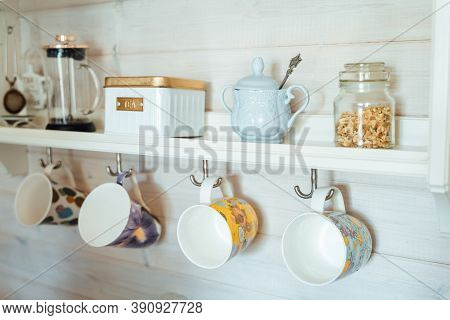 Kitchen Wooden Shelf With Tea Leaves In Gold Box And Accessories, Blue Sugar Bowl With Spoon, Strain