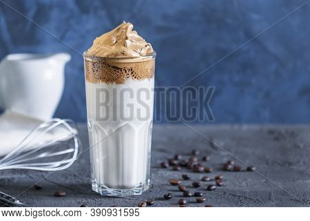 On A Blue Background Dalgon Coffee Close-up. Delicious Popular Drink. Photo With Place For Text.