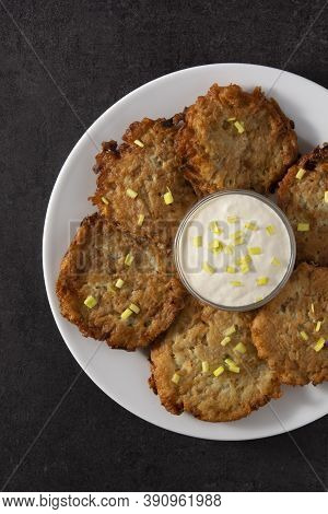 Traditional Jewish Latkes Or Potato Pancakes On Black Background