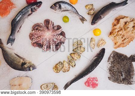 Variety Of Fish And Seafood On Ice Bed.