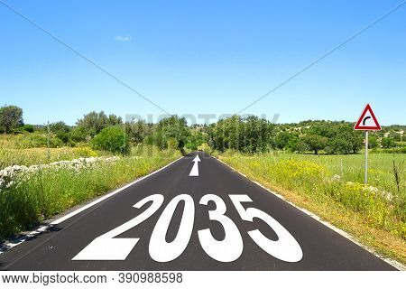 Happy New Year 2035, Road.
Asphalt Road With 2035 Inscription And A Directional Arrow.