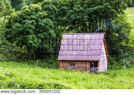 Zakan, Russia - June 24, 2010: Caucasus Mountains Countryside. Hunter's Rustic Hut In Forest On Glad