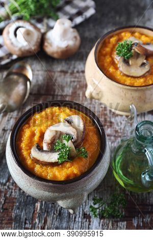 Vegetable Carrot Soup Puree With Mushroom And Parsley Dressing In Two Ceramic Tureen. Rustic Style