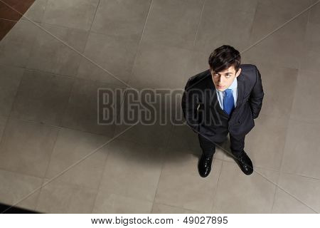 Young businessman looking above