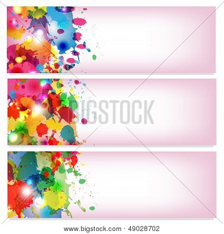 spots of varicoloured paint on a pink background