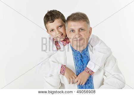 Young boy is hugging his father isolated on white