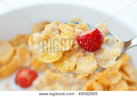 Corn flakes, milk, strawberries.
