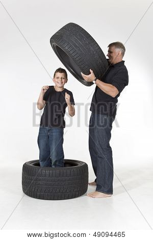 Father is putting tires around his son