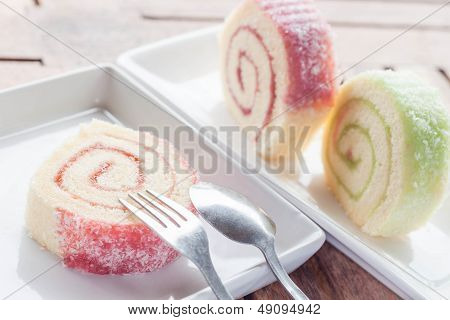 Slice Of Colorful Jam Roll On Wood Table