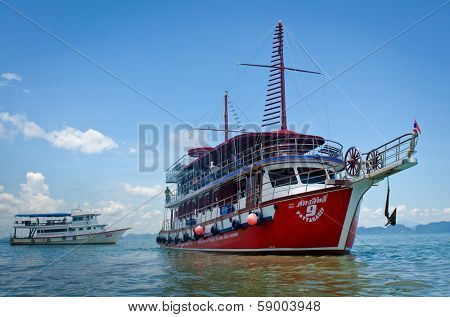 BANG TAO, THAILAND - MAY 15, 2013: Tourist boat in Andaman Sea, May 15, 2013 in Bang Tao, Thailand. Every year 20 million tourists visit Thailand