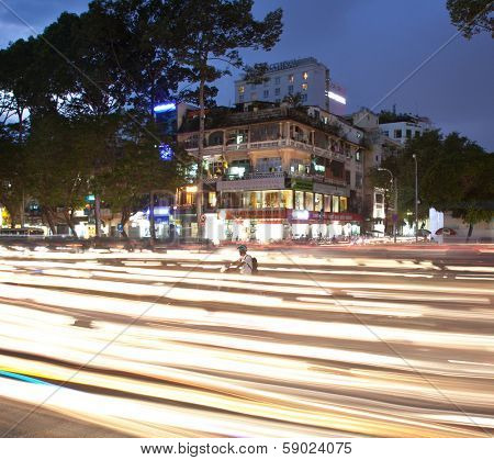 SAIGON - NOV 18, 2013: Road Traffic at evening on Nov 18, 2013 in Saigon (Ho Chi Minh City), Vietnam. Saigon is the largest city in Vietnam. Most popular mean of transport in Vietnam is a motorbike.