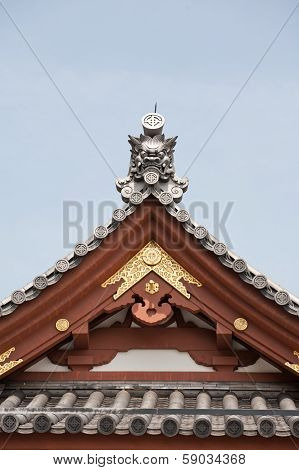 Detail On Japanese Temple Roof Against Blue Sky