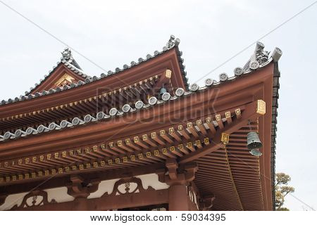 Detail On Japanese Temple Roof Against Blue Sky.
