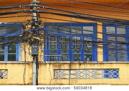 A Tangle Of Cables And Wires On Front Of Window