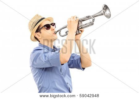 Young male musician playing trumpet isolated on white background