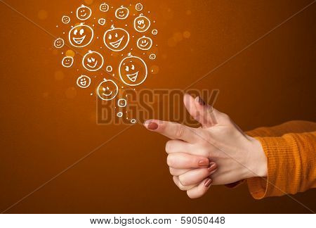 Group of happy hand drawed smiley faces coming out of gun shaped hands