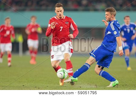 VIENNA,  AUSTRIA - MARCH 22 Marko Arnautovic (#7 Austria) and Rogvi Baldvinson (#5 Faroe Islands) fight for the ball during the world cup qualifier game on March 22, 2013 in Vienna, Austria.
