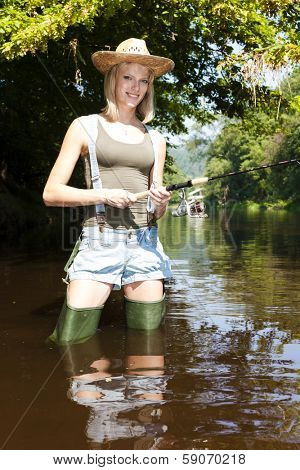 woman fishing in Jizera river, Czech Republic