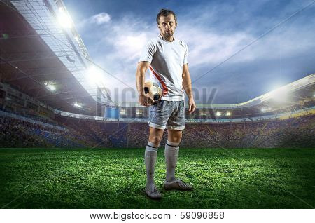 Football player with ball on field of stadium