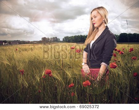 Woman in poppy field smiling
