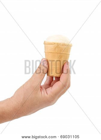 Hand holds empty ice cream corn.