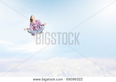 Young woman sitting on chair and meditating