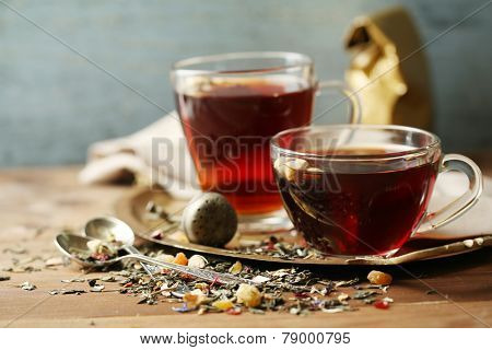 Beautiful vintage composition with herbal tea, on wooden table