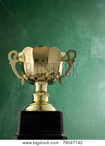 gold trophy against black board