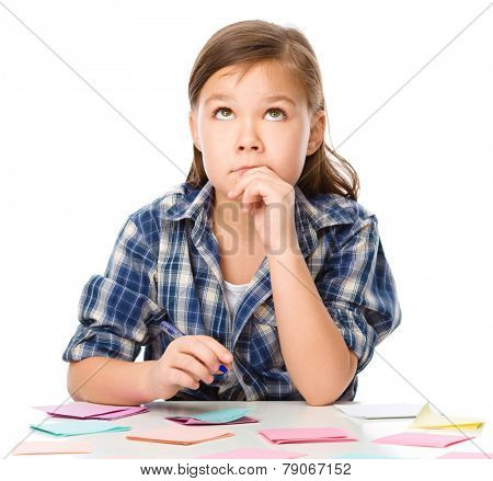 Girl is writing on color stickers using pen, planning concept, self-organization, isolated over white